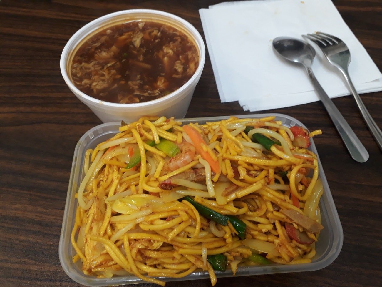 Chow mein noodles with a tub of hot and sour soup